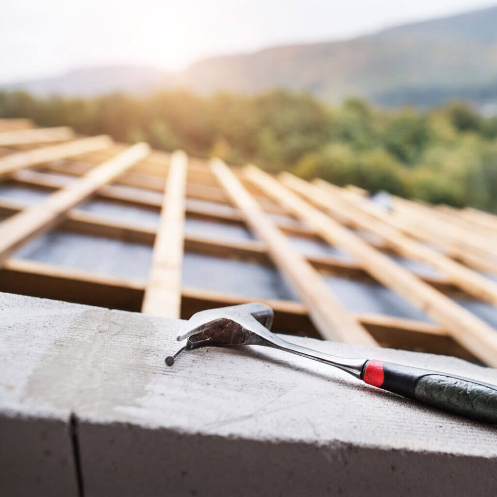 Hammer on the roof on the construction site. Hammer on a new roof construction project